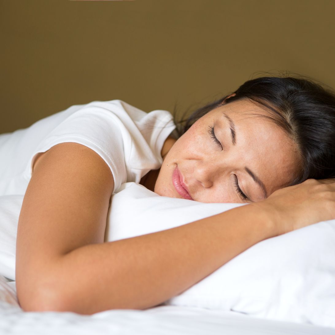 Vrouw ligt met hoofd op kussen te slapen, vermoedelijk in een bed van Swiss Sense Breda